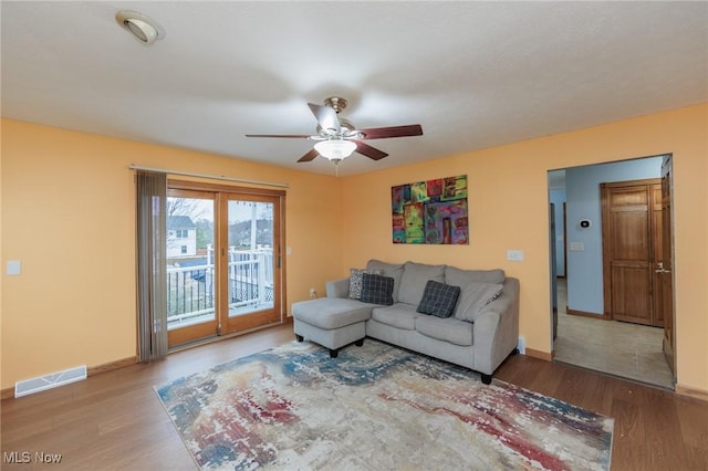 living room with ceiling fan and wood-type flooring