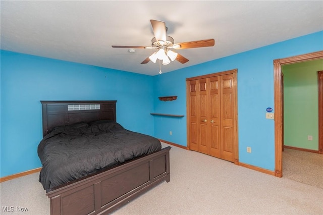 carpeted bedroom with a closet and ceiling fan