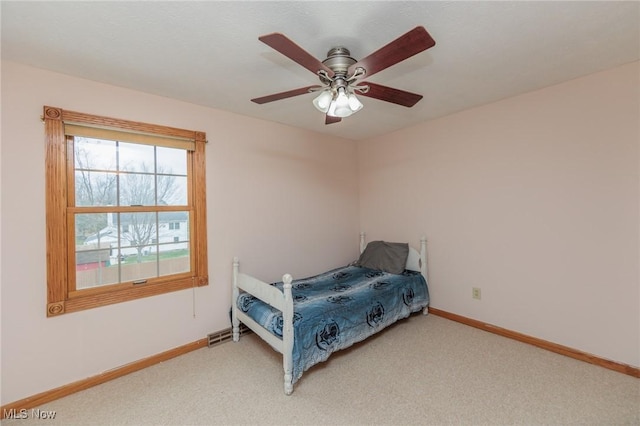 carpeted bedroom featuring ceiling fan