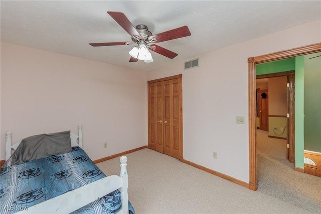 bedroom featuring ceiling fan, a closet, and carpet floors