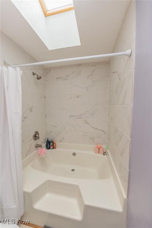 bathroom with shower / bath combination with curtain and a skylight