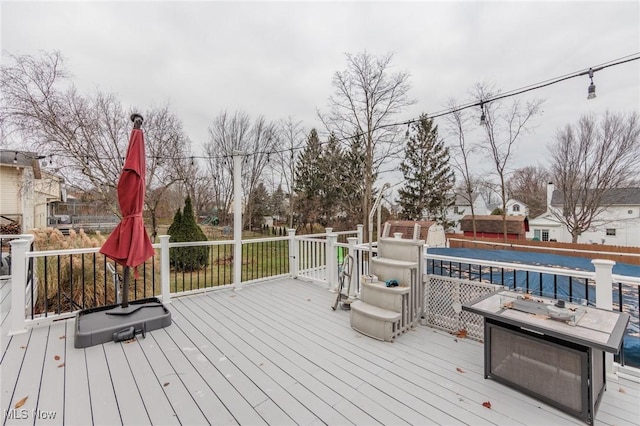 wooden deck featuring an outdoor fire pit