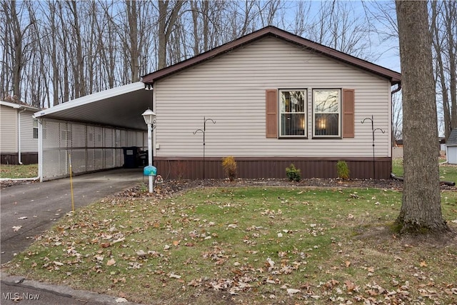 view of home's exterior featuring a lawn and a carport