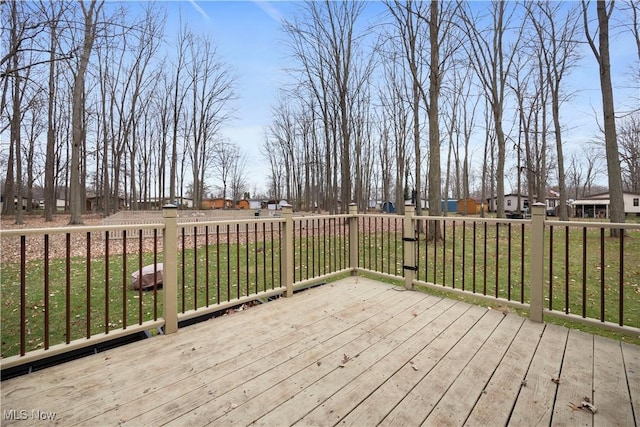 wooden deck with a lawn