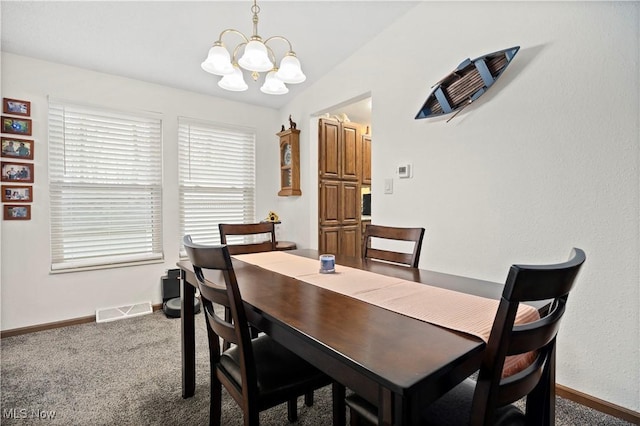 carpeted dining space featuring an inviting chandelier and lofted ceiling