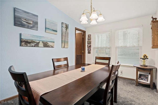 carpeted dining area with vaulted ceiling and an inviting chandelier