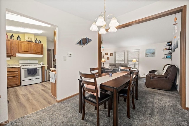 dining area with a chandelier and wood-type flooring