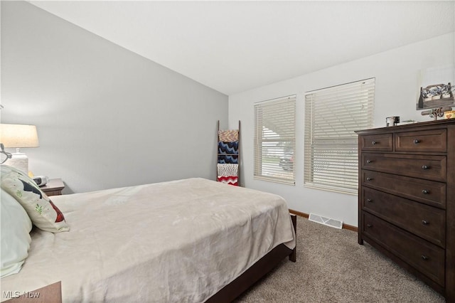 carpeted bedroom with vaulted ceiling