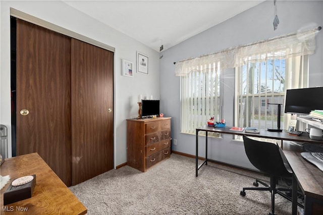 home office with light colored carpet and lofted ceiling