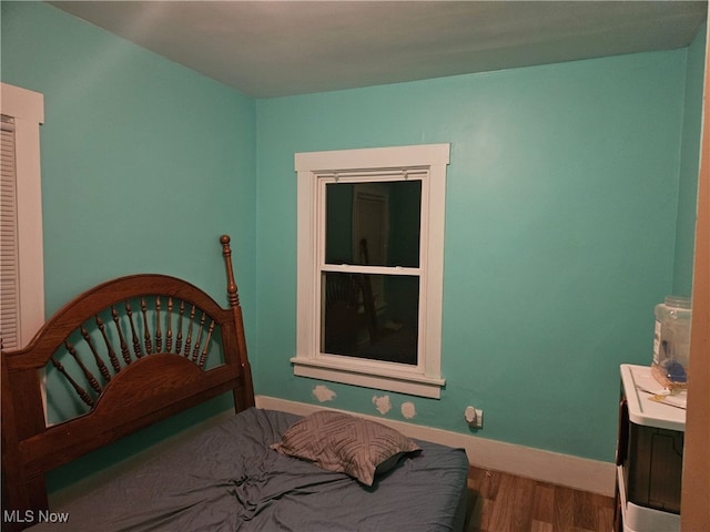 bedroom with hardwood / wood-style floors