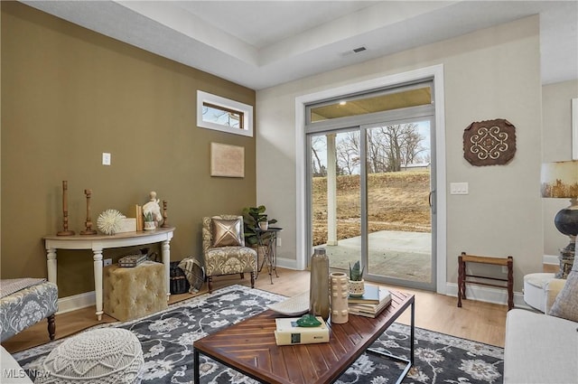 interior space with hardwood / wood-style floors and a tray ceiling