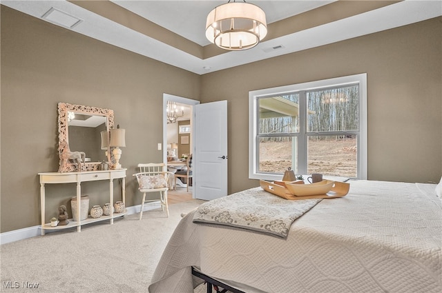 bedroom featuring carpet and an inviting chandelier