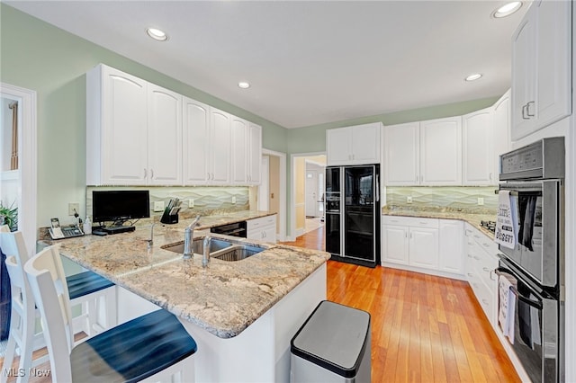 kitchen featuring kitchen peninsula, white cabinets, and tasteful backsplash