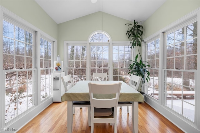 sunroom / solarium with lofted ceiling and a healthy amount of sunlight