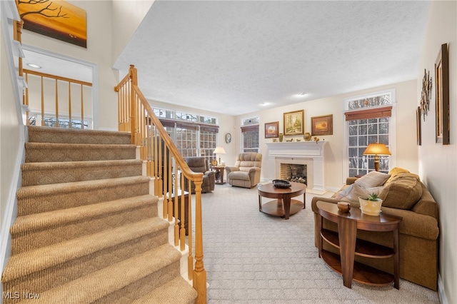 carpeted living room featuring a textured ceiling