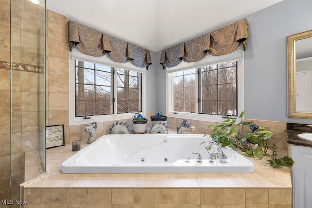 bathroom with vanity and tiled bath