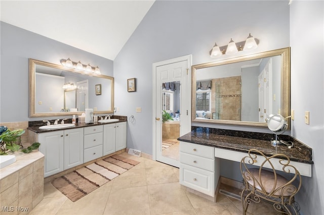 bathroom with plus walk in shower, vanity, high vaulted ceiling, and tile patterned floors