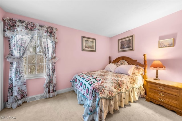 bedroom with light colored carpet