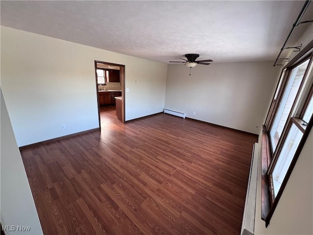 unfurnished room featuring a baseboard radiator, a textured ceiling, ceiling fan, and dark hardwood / wood-style flooring