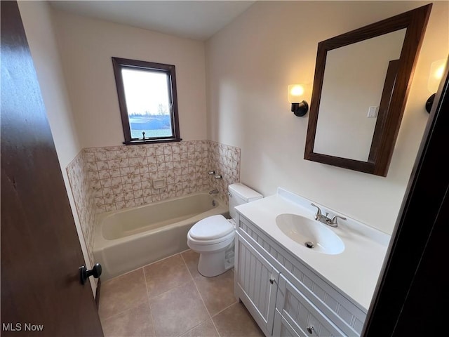 bathroom with vanity, toilet, tile patterned floors, and a tub to relax in