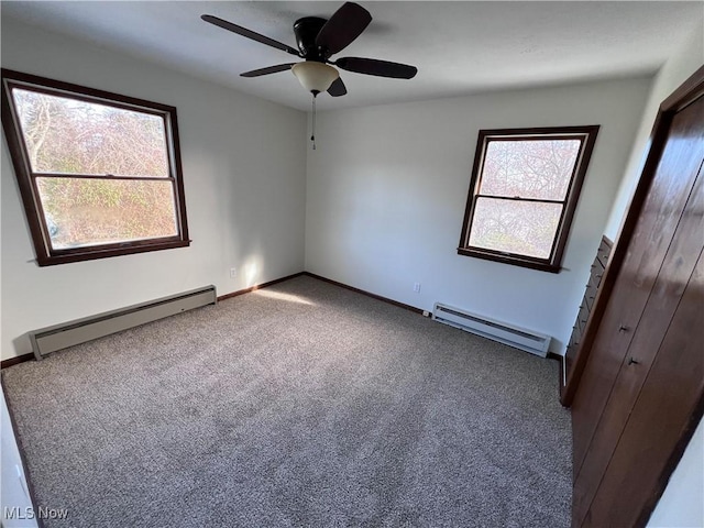 spare room with ceiling fan, a baseboard radiator, and carpet floors