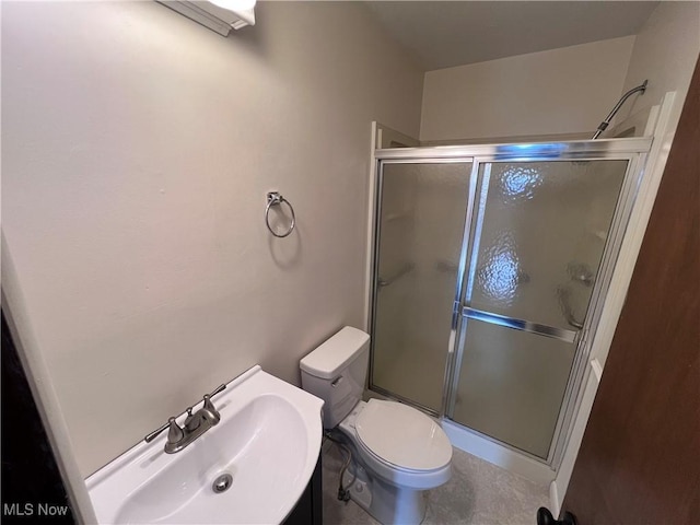 bathroom with toilet, a shower with door, and sink