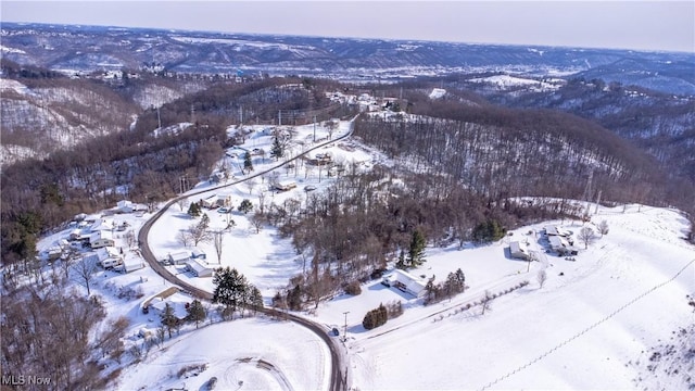 snowy aerial view with a mountain view