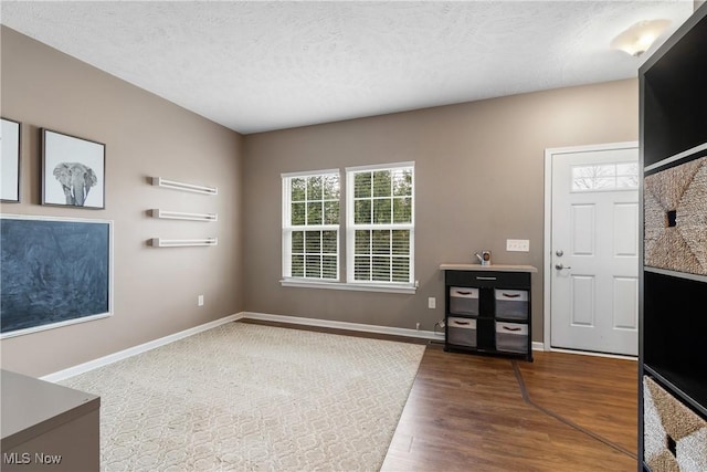 foyer entrance with a textured ceiling and hardwood / wood-style flooring