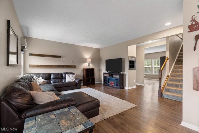 living room featuring a fireplace and dark wood-type flooring