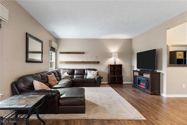 living room featuring a fireplace and wood-type flooring