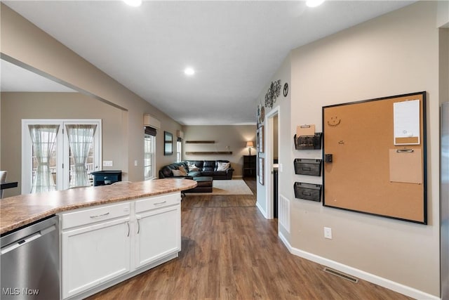 kitchen featuring dishwasher, wood-type flooring, and white cabinetry