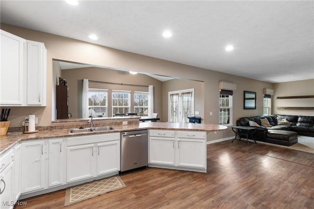 kitchen featuring white cabinets, dishwasher, sink, and hardwood / wood-style flooring