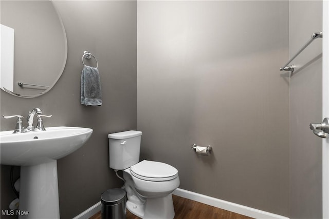 bathroom featuring hardwood / wood-style floors, toilet, and sink