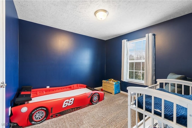 bedroom featuring carpet flooring and a textured ceiling