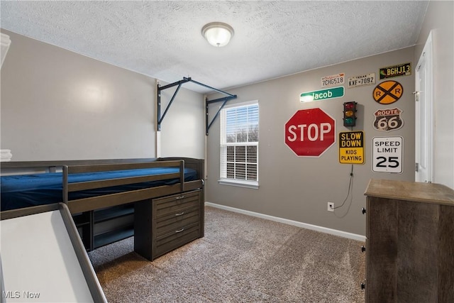 carpeted bedroom with a textured ceiling