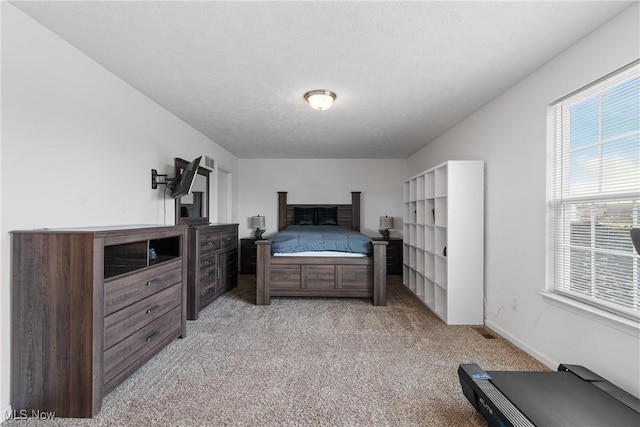 carpeted bedroom featuring a textured ceiling