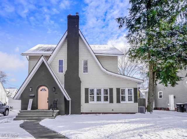 view of snow covered back of property