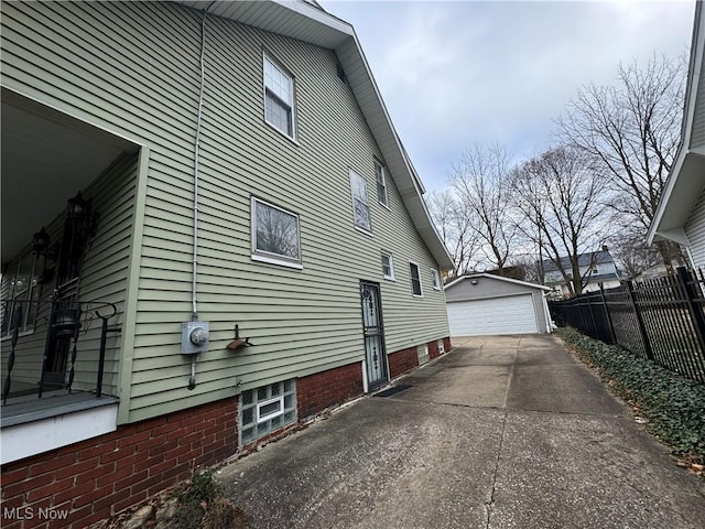 view of side of home featuring a garage and an outdoor structure