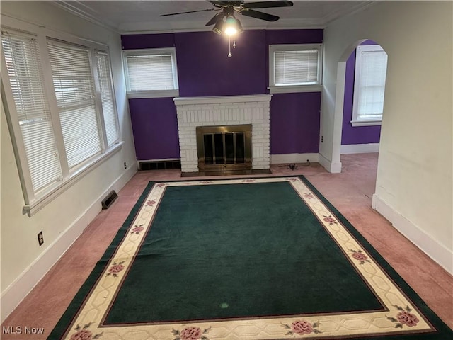 interior space with ceiling fan, ornamental molding, and a fireplace