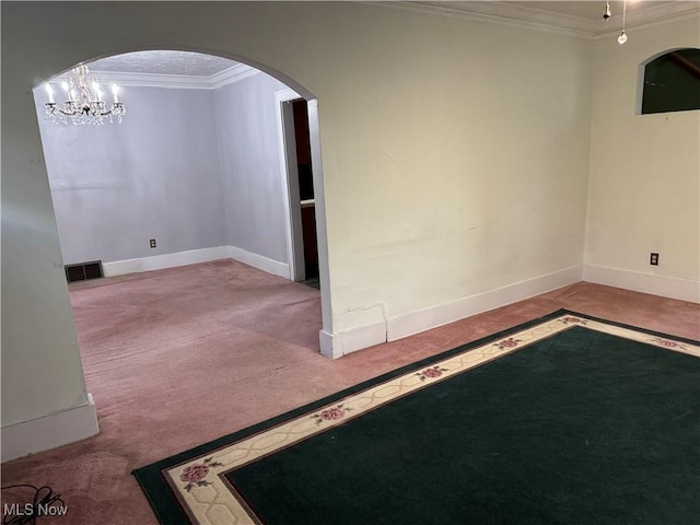 empty room with light colored carpet, crown molding, and an inviting chandelier