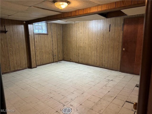 basement featuring wood walls