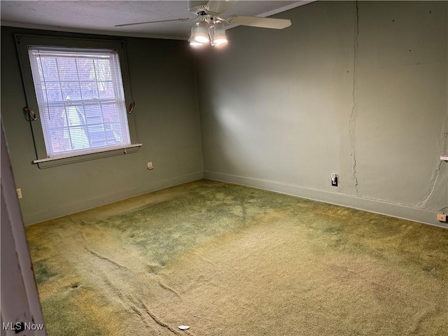 carpeted spare room with ceiling fan