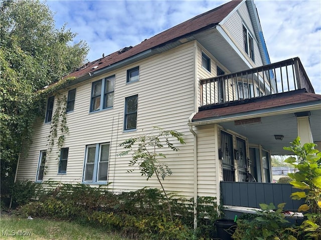 view of side of home with a balcony