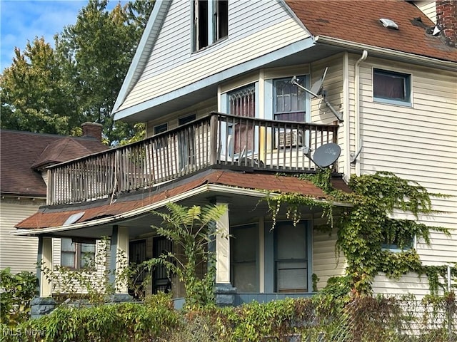 back of property featuring a balcony