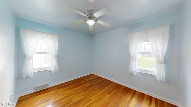 spare room featuring hardwood / wood-style floors and ceiling fan