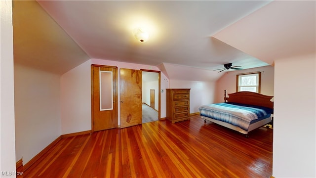 bedroom with ceiling fan, vaulted ceiling, and hardwood / wood-style flooring