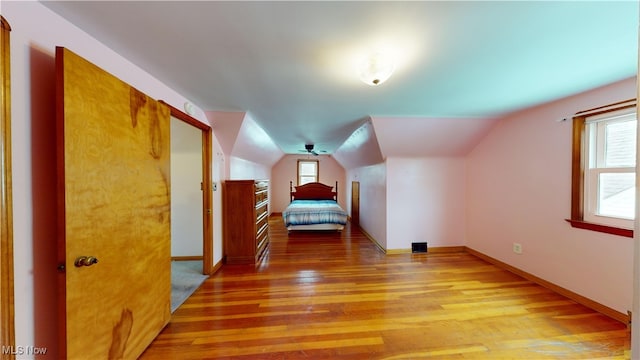 unfurnished bedroom featuring light hardwood / wood-style floors and vaulted ceiling