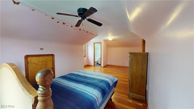 bedroom with ceiling fan, lofted ceiling, and hardwood / wood-style flooring