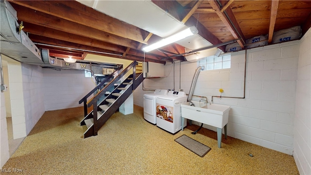 basement with sink and washing machine and clothes dryer