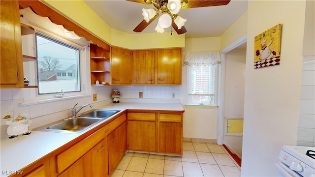 kitchen with backsplash, electric stove, sink, ceiling fan, and light tile patterned floors